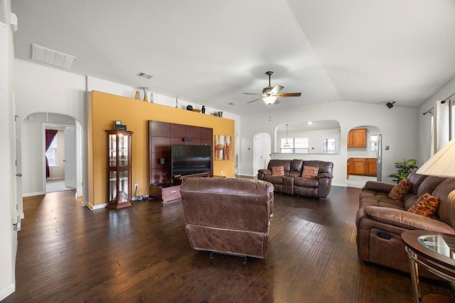 2801 Stirrup Cv, Leander, TX 78641 - living room with arched walkways, a ceiling fan, healthy amount of natural light, dark wood finished floors, and lofted ceiling
