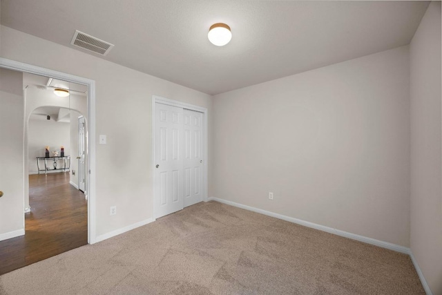 2801 Stirrup Cv, Leander, TX 78641 - unfurnished bedroom with carpet, baseboards, arched walkways, and a closet