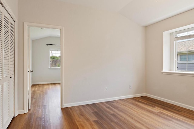 1900 Scofield Ridge Parkway Unit 1703, Austin, TX 78727 - unfurnished room with lofted ceiling, wood finished floors, and baseboards