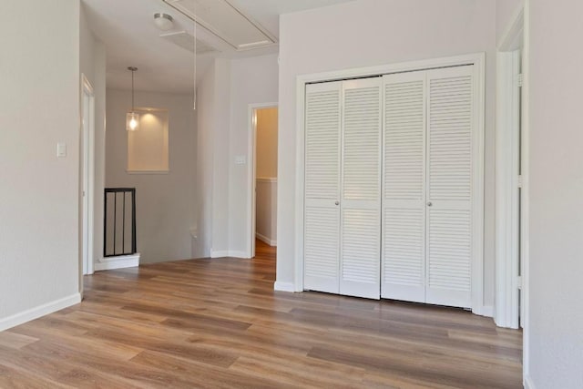 1900 Scofield Ridge Parkway Unit 1703, Austin, TX 78727 - corridor with attic access, light wood-style floors, and baseboards