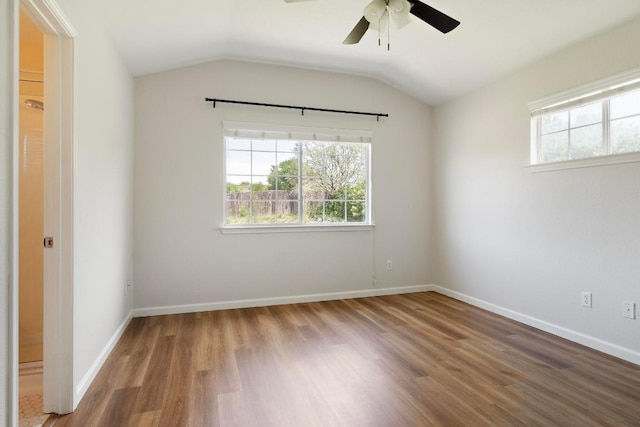 1900 Scofield Ridge Parkway Unit 1703, Austin, TX 78727 - empty room with healthy amount of natural light, wood finished floors, a ceiling fan, lofted ceiling, and baseboards