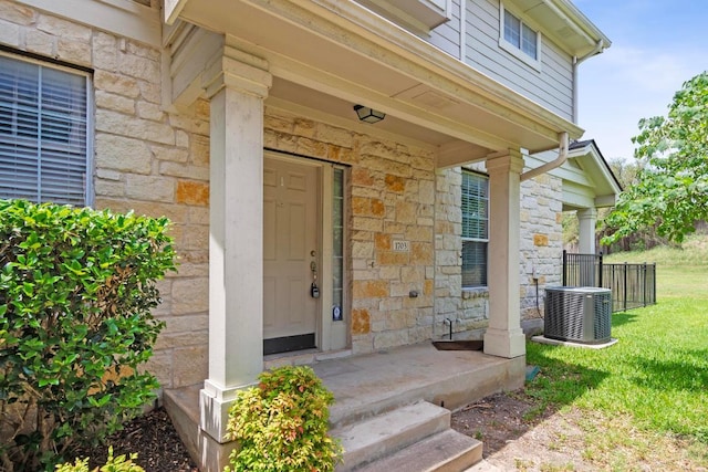1900 Scofield Ridge Parkway Unit 1703, Austin, TX 78727 - property entrance featuring stone siding, central AC unit, and a yard