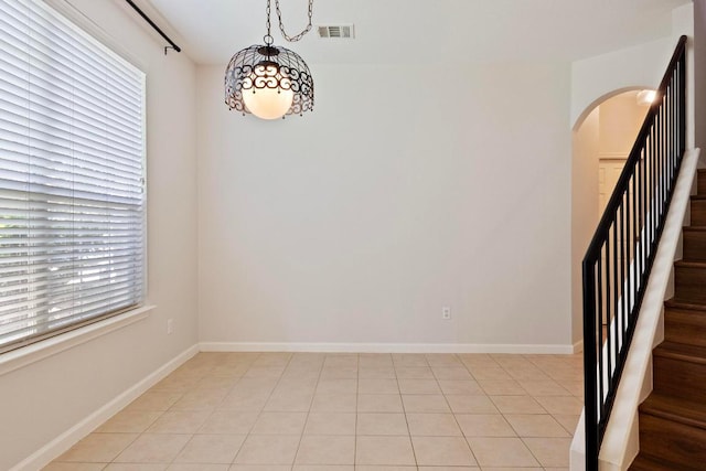 1900 Scofield Ridge Parkway Unit 1703, Austin, TX 78727 - empty room with arched walkways, stairway, and baseboards
