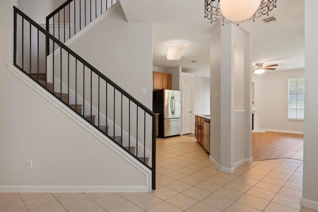 1900 Scofield Ridge Parkway Unit 1703, Austin, TX 78727 - entrance foyer featuring ceiling fan, baseboards, stairway, and light tile patterned floors