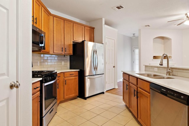 1900 Scofield Ridge Parkway Unit 1703, Austin, TX 78727 - kitchen featuring stainless steel appliances, a sink, backsplash, and light countertops