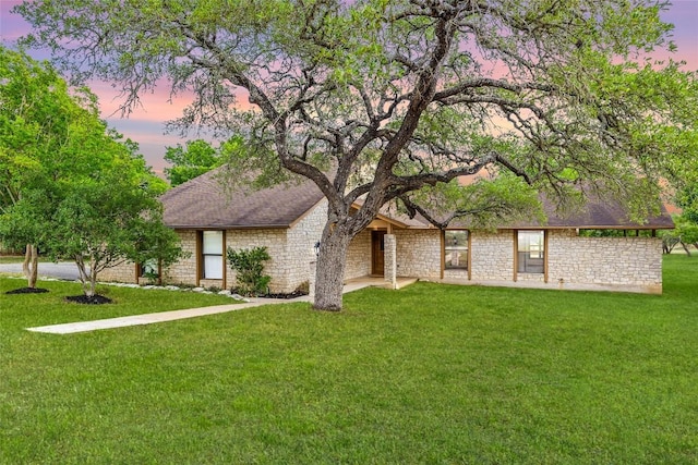 708 Post Oak Dr, Dripping Springs, TX 78620 - view of front facade with stone siding and a lawn