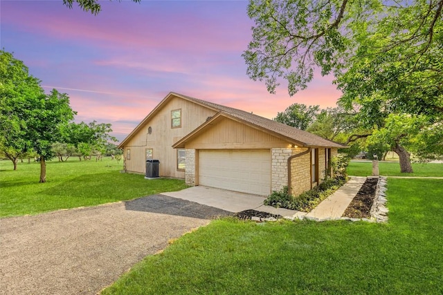 708 Post Oak Dr, Dripping Springs, TX 78620 - view of front of property featuring a yard, central AC unit, asphalt driveway, and brick siding