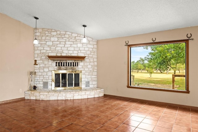 708 Post Oak Dr, Dripping Springs, TX 78620 - unfurnished living room featuring vaulted ceiling, a textured ceiling, tile patterned flooring, and a fireplace