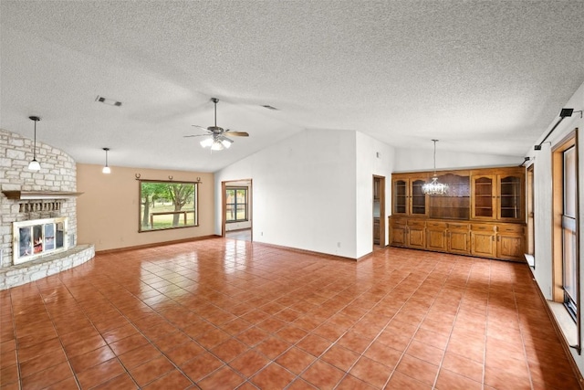 708 Post Oak Dr, Dripping Springs, TX 78620 - unfurnished living room featuring lofted ceiling, a textured ceiling, a chandelier, light tile patterned floors, and a fireplace