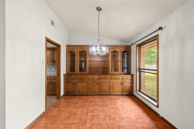 708 Post Oak Dr, Dripping Springs, TX 78620 - unfurnished dining area featuring a chandelier, vaulted ceiling, a textured ceiling, and light tile patterned floors