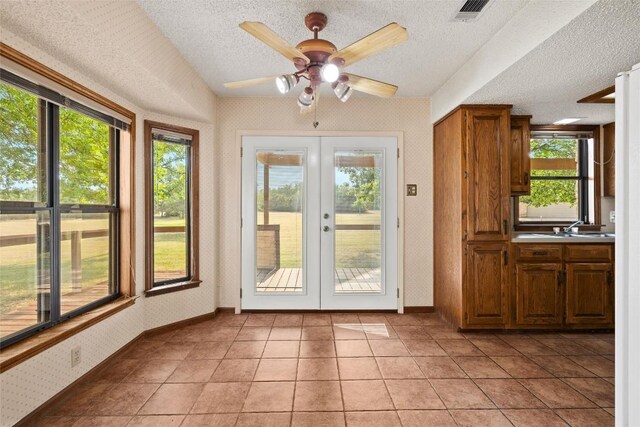 708 Post Oak Dr, Dripping Springs, TX 78620 - doorway to outside featuring french doors, a textured ceiling, baseboards, ceiling fan, and wallpapered walls