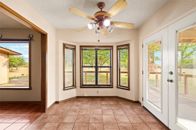 708 Post Oak Dr, Dripping Springs, TX 78620 - unfurnished sunroom with french doors, tile patterned flooring, a textured ceiling, and baseboards