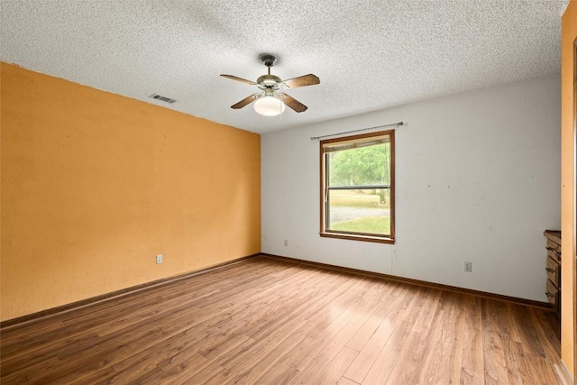 708 Post Oak Dr, Dripping Springs, TX 78620 - unfurnished room featuring a ceiling fan, wood finished floors, a textured ceiling, and baseboards