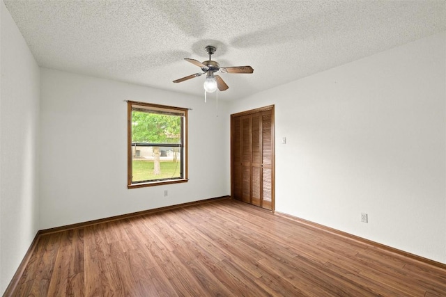 708 Post Oak Dr, Dripping Springs, TX 78620 - spare room featuring light wood finished floors, ceiling fan, a textured ceiling, and baseboards