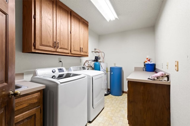 708 Post Oak Dr, Dripping Springs, TX 78620 - washroom featuring cabinet space, washer and clothes dryer, and light floors