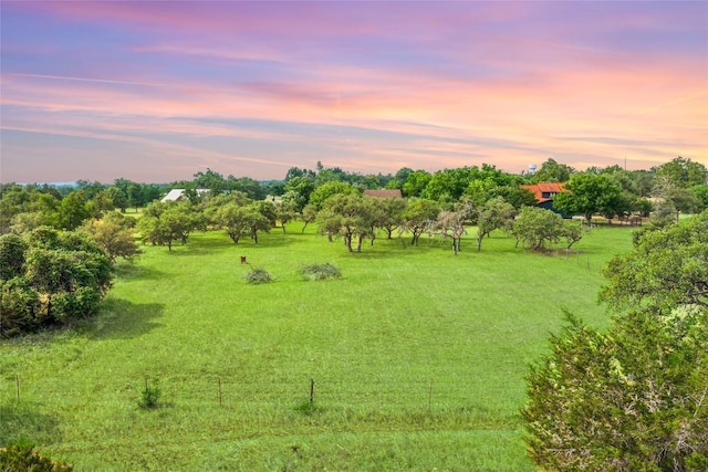 708 Post Oak Dr, Dripping Springs, TX 78620 - yard at dusk featuring a rural view and a lawn