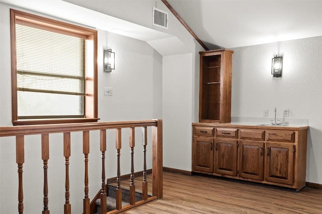 708 Post Oak Dr, Dripping Springs, TX 78620 - hallway with a sink, light wood-style flooring, healthy amount of natural light, and baseboards