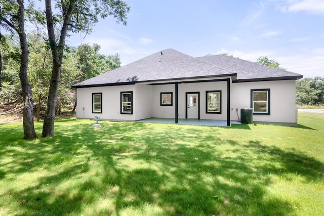 147 Puu Waa Waa Ln, Bastrop, TX 78602 - rear view of property featuring roof with shingles, central air condition unit, a patio area, stucco siding, and a yard