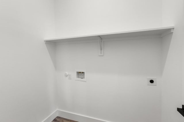 147 Puu Waa Waa Ln, Bastrop, TX 78602 - washroom with washer hookup, hookup for an electric dryer, and dark wood-style floors