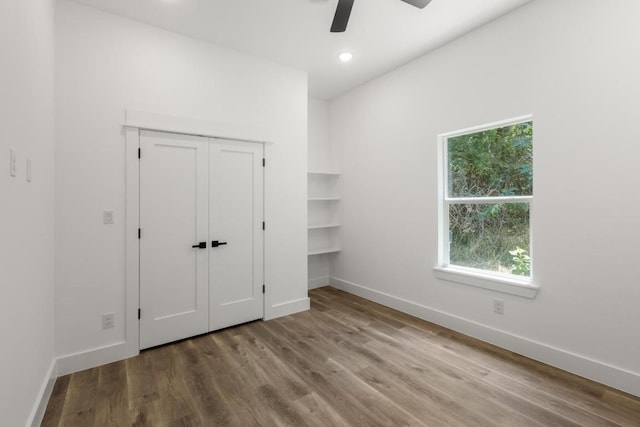 147 Puu Waa Waa Ln, Bastrop, TX 78602 - unfurnished bedroom with wood finished floors, ceiling fan, and recessed lighting