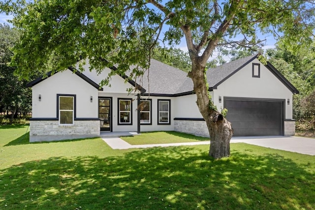 147 Puu Waa Waa Ln, Bastrop, TX 78602 - modern farmhouse featuring stone siding, stucco siding, concrete driveway, a front yard, and a garage