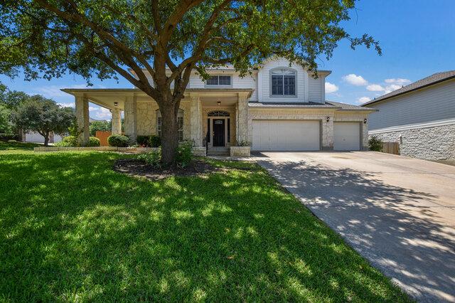 14800 Banbridge Trl, Austin, TX 78717 - traditional-style home with concrete driveway, a front yard, stone siding, and an attached garage