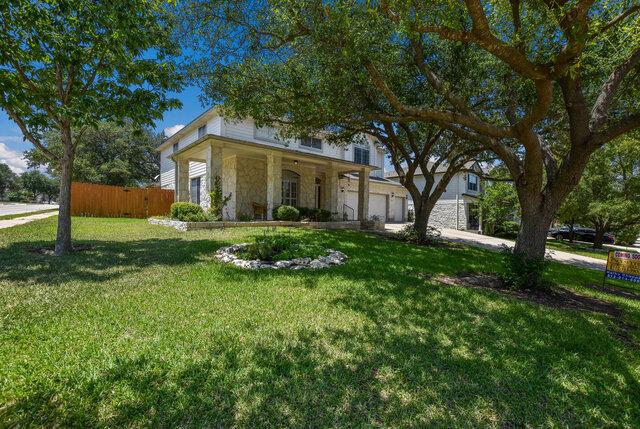 14800 Banbridge Trl, Austin, TX 78717 - obstructed view of property with stone siding and an attached garage