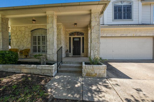 14800 Banbridge Trl, Austin, TX 78717 - view of exterior entry featuring driveway, stone siding, and a garage