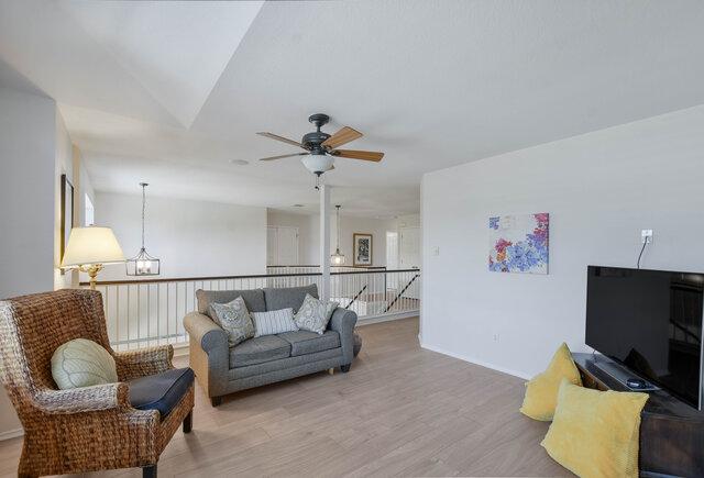 14800 Banbridge Trl, Austin, TX 78717 - living room featuring light wood-style flooring, ceiling fan, and a chandelier