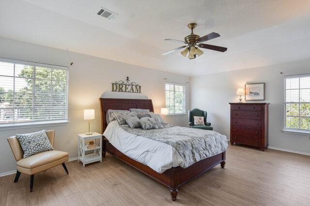 14800 Banbridge Trl, Austin, TX 78717 - bedroom featuring light wood-style flooring, baseboards, and ceiling fan
