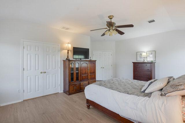 14800 Banbridge Trl, Austin, TX 78717 - bedroom featuring light wood finished floors, multiple closets, and a ceiling fan