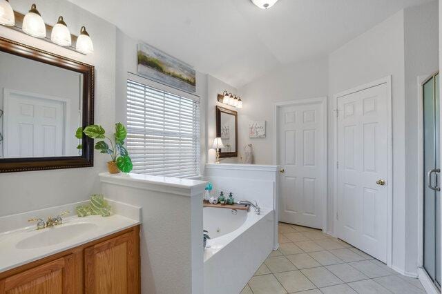 14800 Banbridge Trl, Austin, TX 78717 - full bath with a shower stall, tile patterned flooring, vanity, a whirlpool tub, and lofted ceiling
