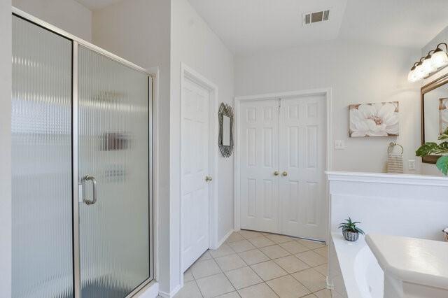 14800 Banbridge Trl, Austin, TX 78717 - bathroom featuring a shower stall, tile patterned floors, and a garden tub