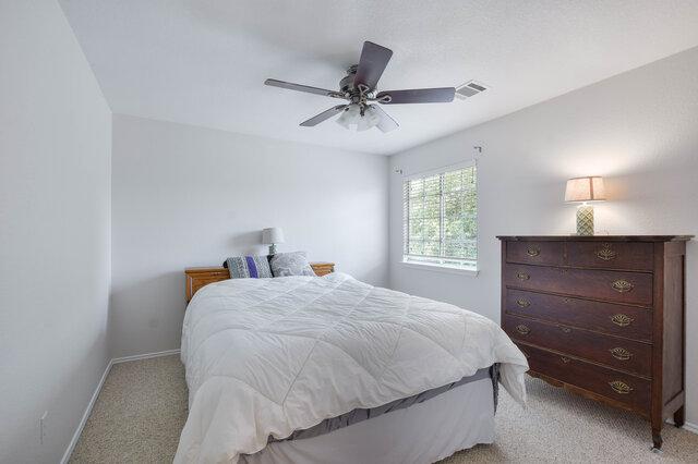 14800 Banbridge Trl, Austin, TX 78717 - bedroom featuring light carpet, baseboards, and a ceiling fan