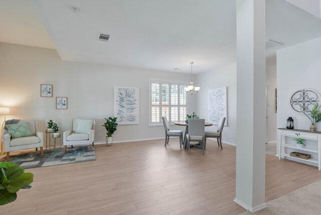 14800 Banbridge Trl, Austin, TX 78717 - dining area with light wood-style flooring and a chandelier