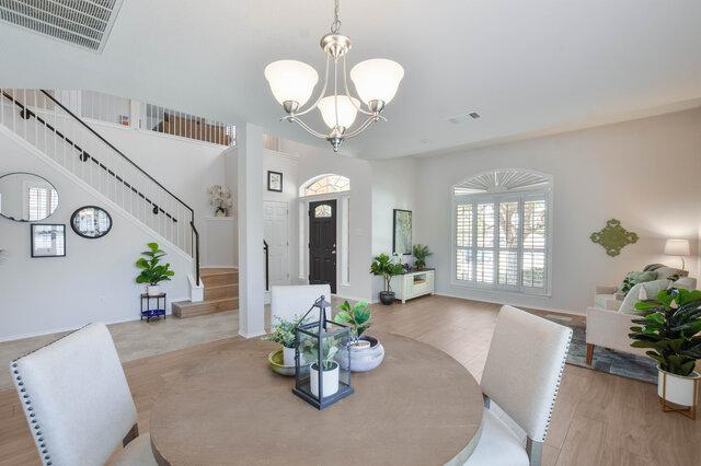 14800 Banbridge Trl, Austin, TX 78717 - dining space featuring stairway, wood finished floors, and a chandelier