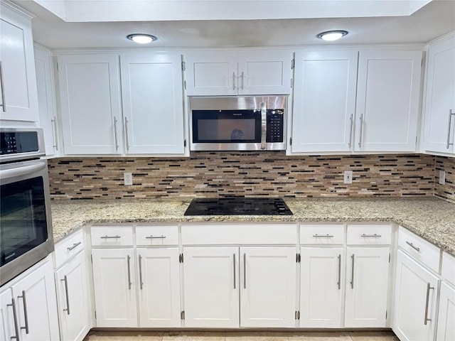 11804 Buckingham Rd, Austin, TX 78759 - kitchen featuring stainless steel appliances, white cabinets, backsplash, and recessed lighting