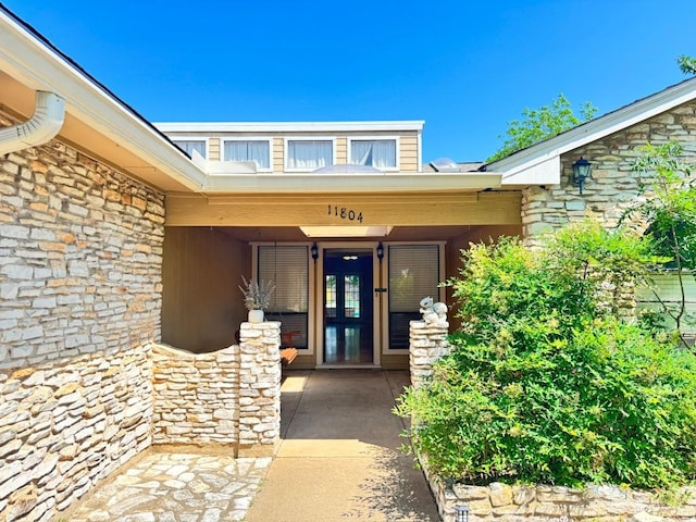 11804 Buckingham Rd, Austin, TX 78759 - doorway to property featuring stone siding