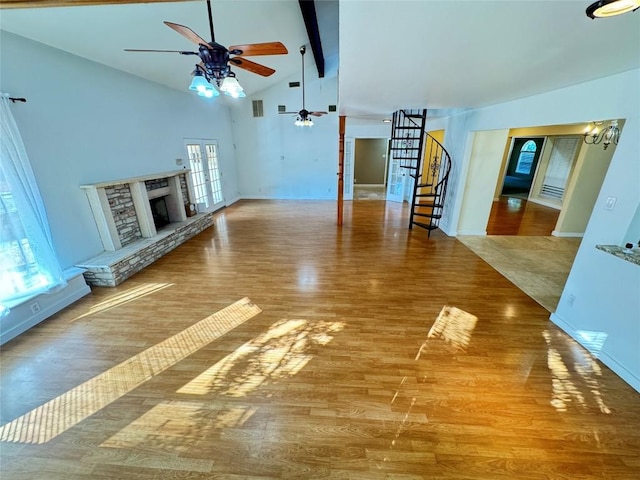 11804 Buckingham Rd, Austin, TX 78759 - unfurnished living room with ceiling fan, stairs, wood finished floors, a fireplace with raised hearth, and baseboards