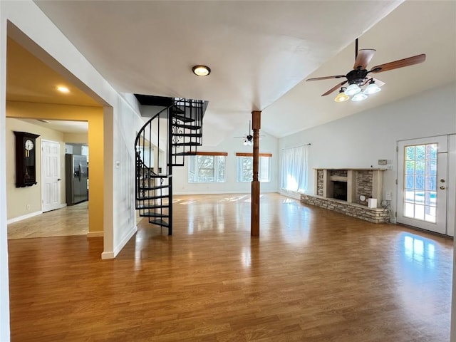 11804 Buckingham Rd, Austin, TX 78759 - unfurnished living room with a ceiling fan, healthy amount of natural light, stairway, lofted ceiling, and wood finished floors