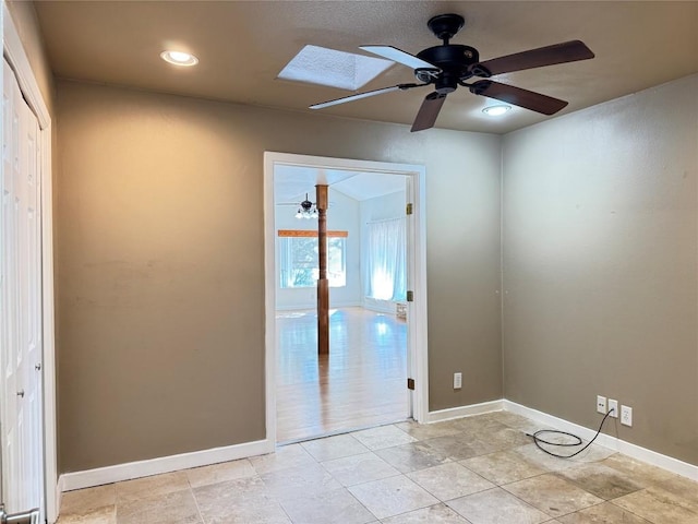 11804 Buckingham Rd, Austin, TX 78759 - empty room featuring ceiling fan, a skylight, baseboards, and recessed lighting