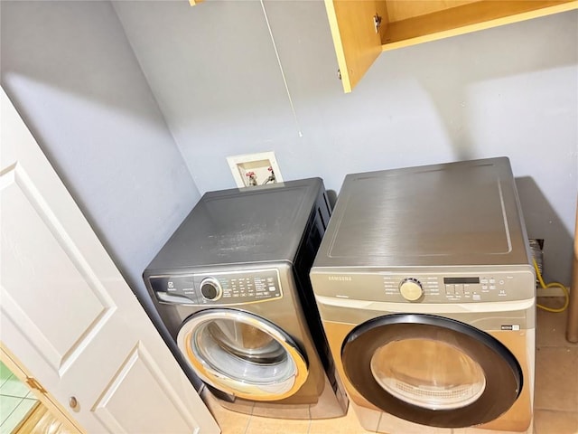 11804 Buckingham Rd, Austin, TX 78759 - laundry room with tile patterned floors and washer and clothes dryer