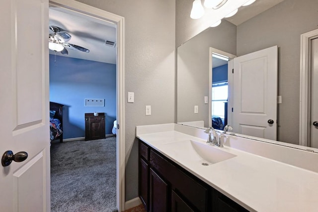 411 Torrington Dr, Austin, TX 78737 - bathroom featuring vanity, a ceiling fan, baseboards, and connected bathroom
