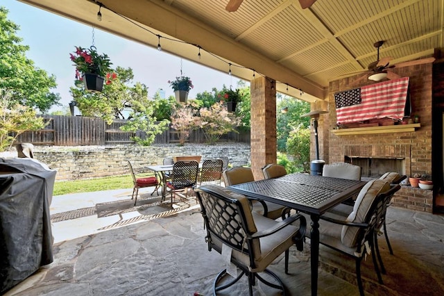 411 Torrington Dr, Austin, TX 78737 - view of patio / terrace with outdoor dining space, an outdoor brick fireplace, and a ceiling fan