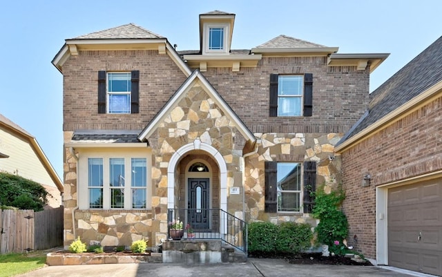 411 Torrington Dr, Austin, TX 78737 - view of front of property featuring stone siding, a garage, and brick siding