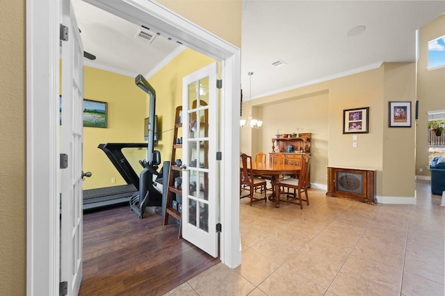 411 Torrington Dr, Austin, TX 78737 - exercise area with crown molding, a chandelier, tile patterned flooring, baseboards, and french doors