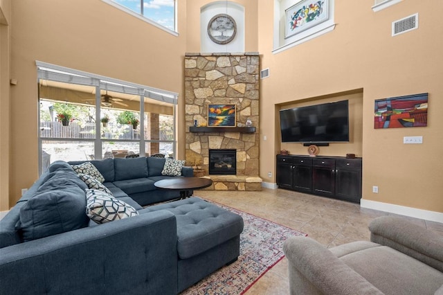 411 Torrington Dr, Austin, TX 78737 - living room with a towering ceiling, baseboards, a fireplace, light tile patterned floors, and a ceiling fan