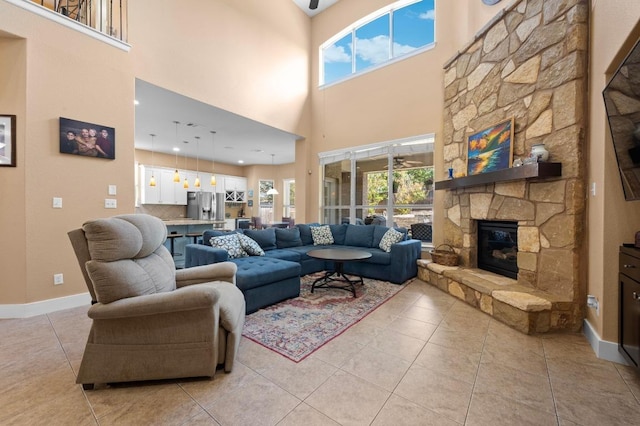 411 Torrington Dr, Austin, TX 78737 - living room with a fireplace, light tile patterned flooring, a towering ceiling, and baseboards