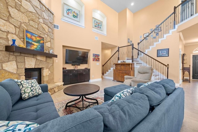 411 Torrington Dr, Austin, TX 78737 - living area with stairs, a towering ceiling, and a stone fireplace