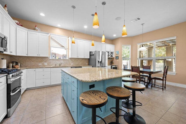411 Torrington Dr, Austin, TX 78737 - kitchen with appliances with stainless steel finishes, a sink, tasteful backsplash, white cabinets, and recessed lighting